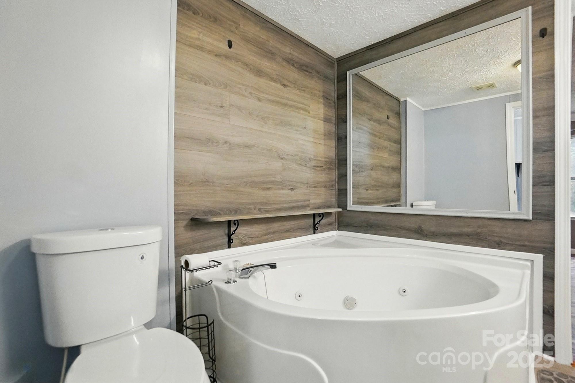 621 Harper Davis Road Lake Wylie, SC 29710 - Photo 16 of 30 a white bath tub sitting next to a white toilet