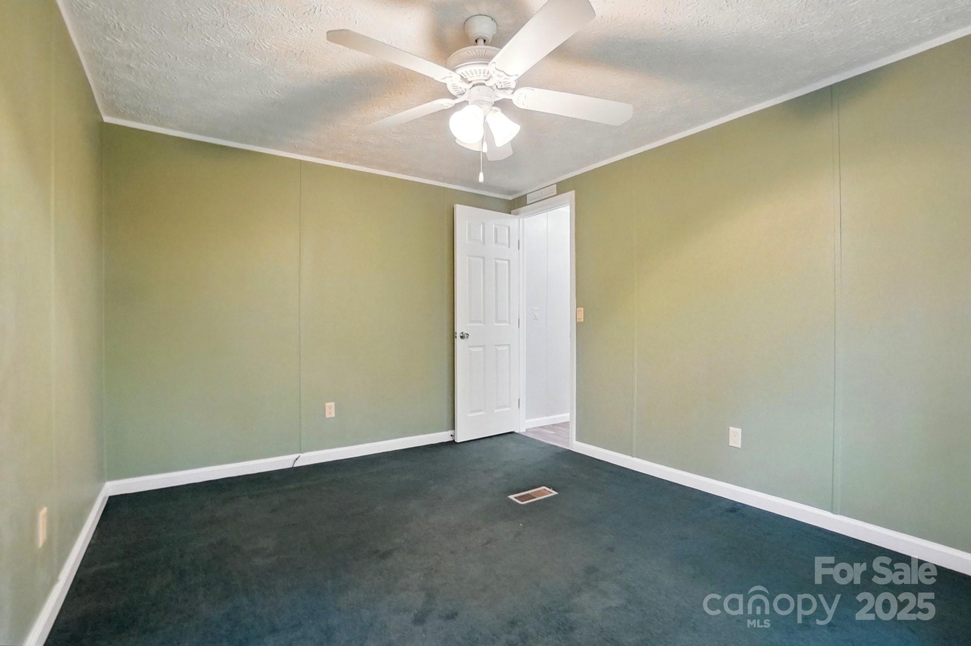 621 Harper Davis Road Lake Wylie, SC 29710 - Photo 20 of 30 an empty room with a ceiling fan and carpet
