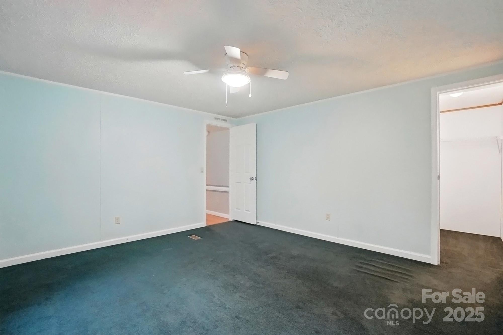 621 Harper Davis Road Lake Wylie, SC 29710 - Photo 22 of 30 an empty room with wooden floor and fan