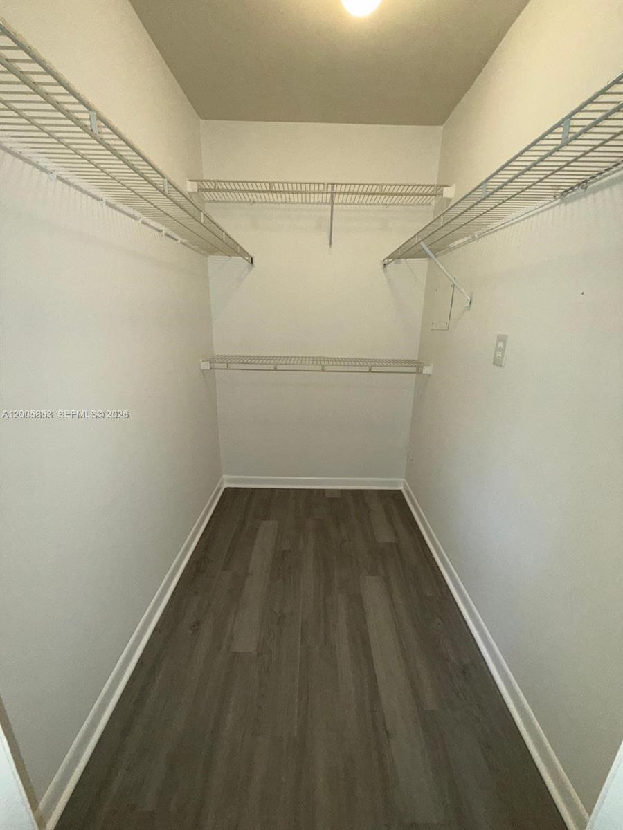 15285 Southwest 107th Lane, Unit 214 Miami, FL 33196 - Photo 13 of 16 a view of a room with racks on the wall