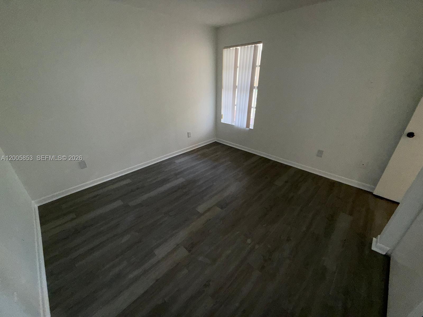 15285 Southwest 107th Lane, Unit 214 Miami, FL 33196 - Photo 10 of 16 a view of an empty room and window