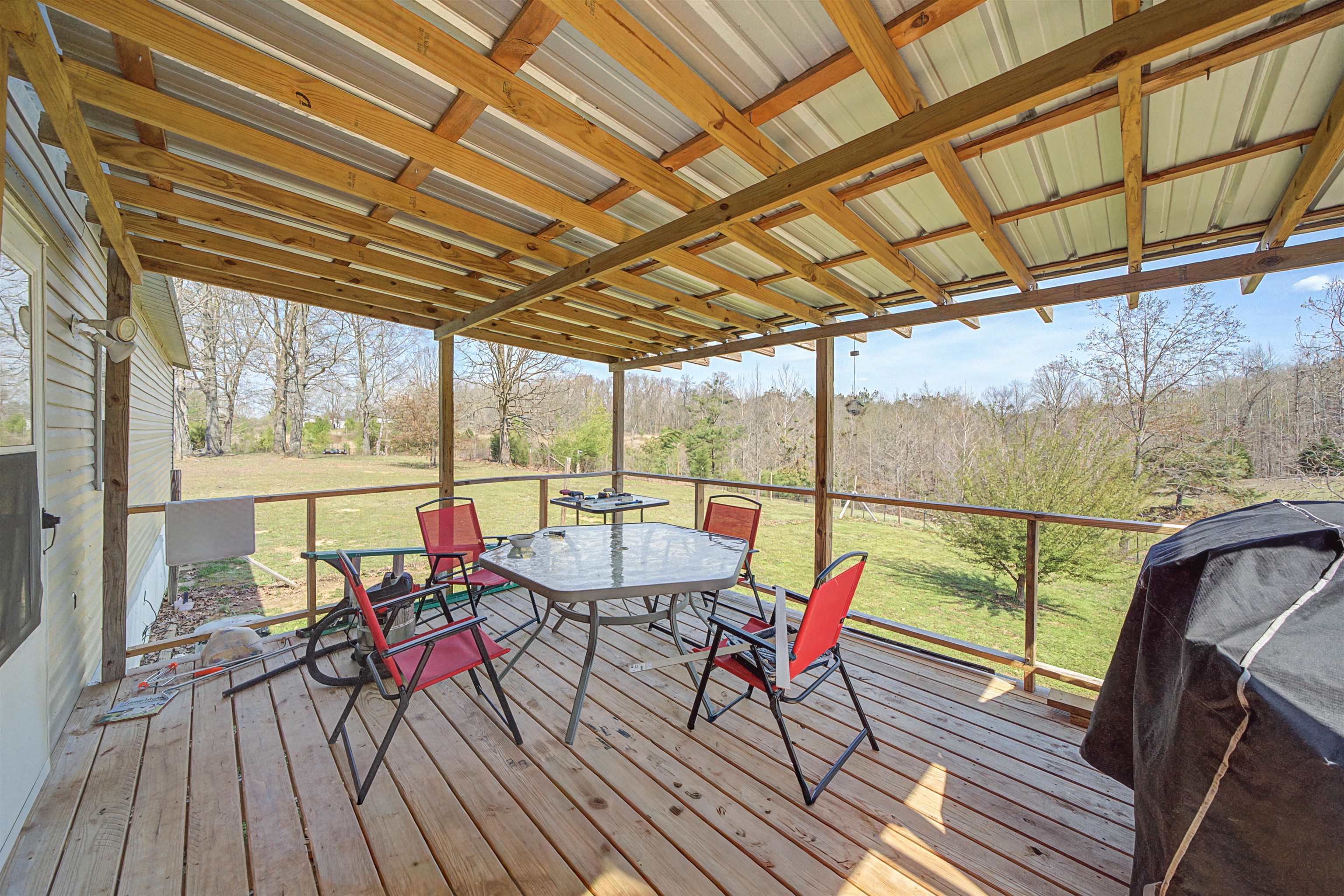 7010 22nd Highway Adamsville, TN 38310 - Photo 19 of 33 Sunroom with outdoor dining area, a wooden deck, and healthy amount of natural light
