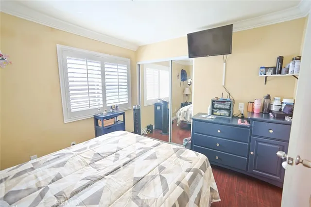 a bedroom with a bed window and cabinet