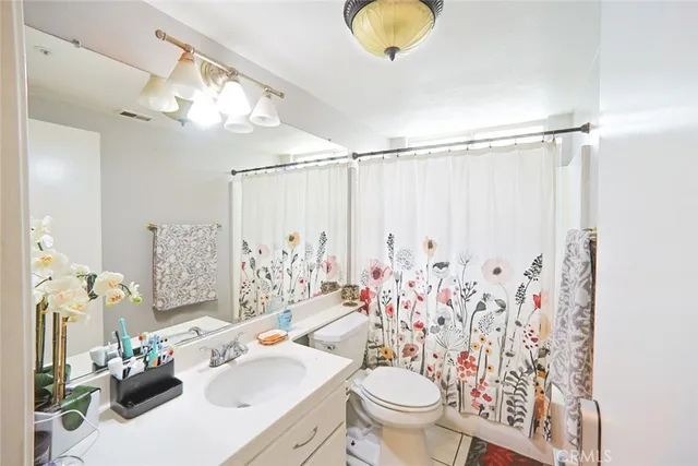 a bathroom with a sink toilet mirror and shower