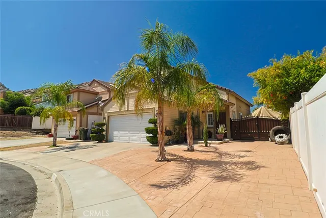 a view of a white house with a snow on the road