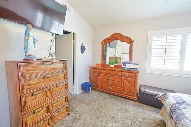 a bedroom with a bed and a dresser