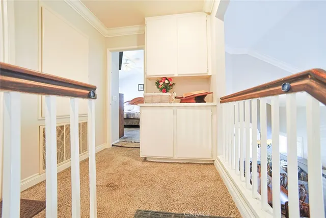 a view of a hallway with wooden floor and stairs
