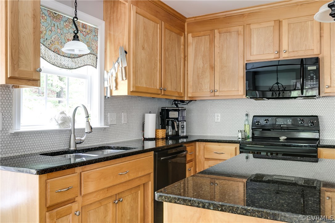 10970 Weybridge Road Chester, VA 23831 - Photo 24 of 35 a kitchen with granite countertop a stove a sink and a microwave