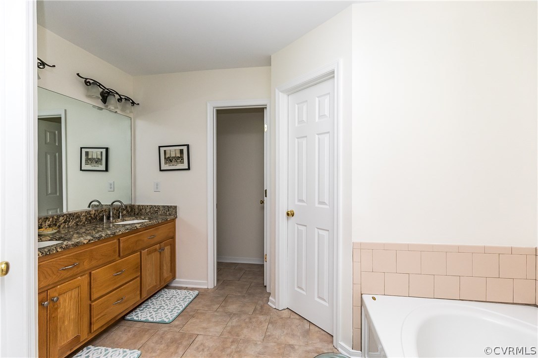 10970 Weybridge Road Chester, VA 23831 - Photo 9 of 35 a spacious bathroom with a granite countertop sink a mirror and shower