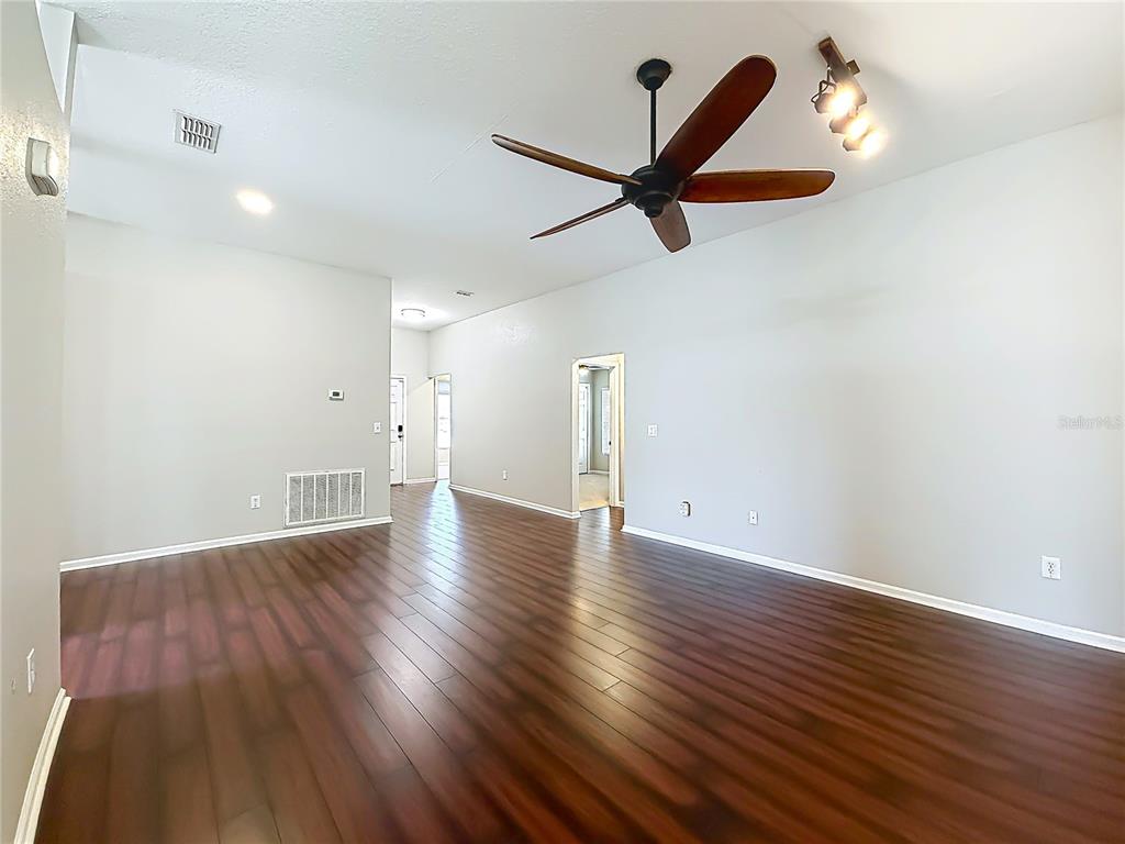 6358 Southwest 155th Place Ocala, FL 34473 - Photo 12 of 55 wooden floor in an empty room with a window