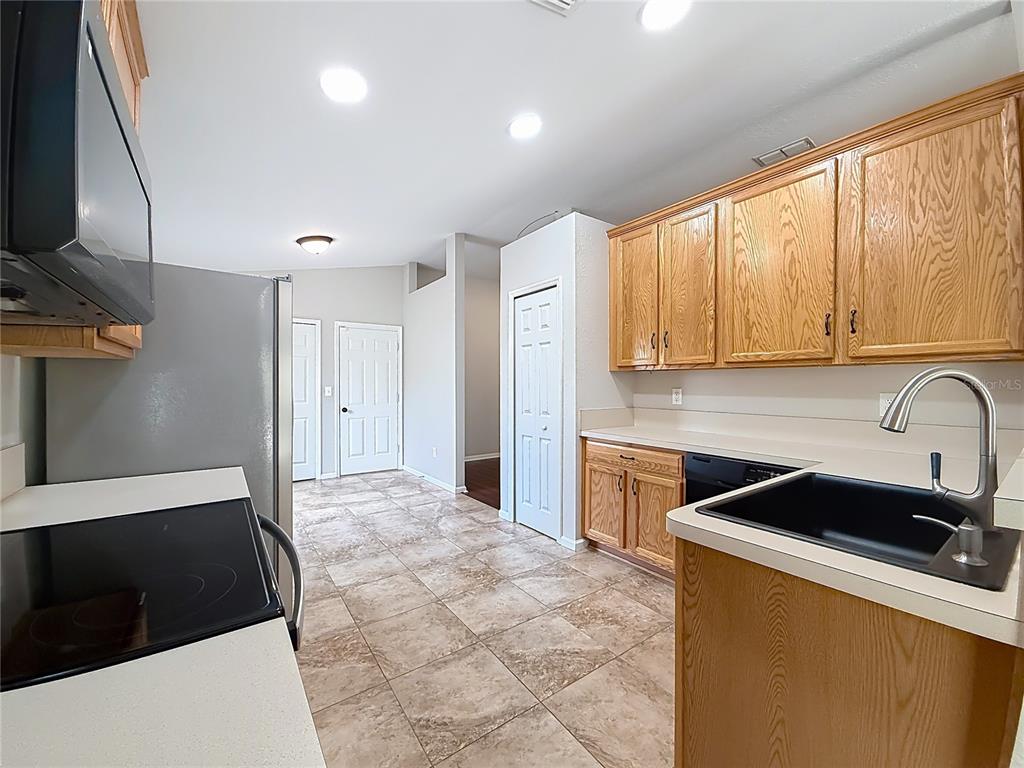 6358 Southwest 155th Place Ocala, FL 34473 - Photo 22 of 55 a kitchen with a sink a stove and cabinets