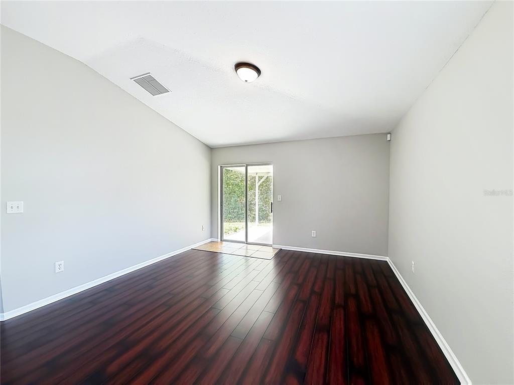 6358 Southwest 155th Place Ocala, FL 34473 - Photo 25 of 55 an empty room with wooden floor and windows
