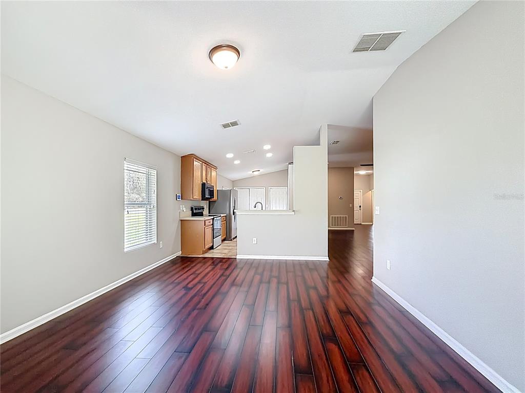 6358 Southwest 155th Place Ocala, FL 34473 - Photo 27 of 55 a view of a kitchen with wooden floor and electronic appliances
