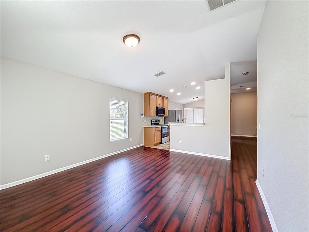 6358 Southwest 155th Place Ocala, FL 34473 - Photo 28 of 55 a view of a kitchen with wooden floor and electronic appliances