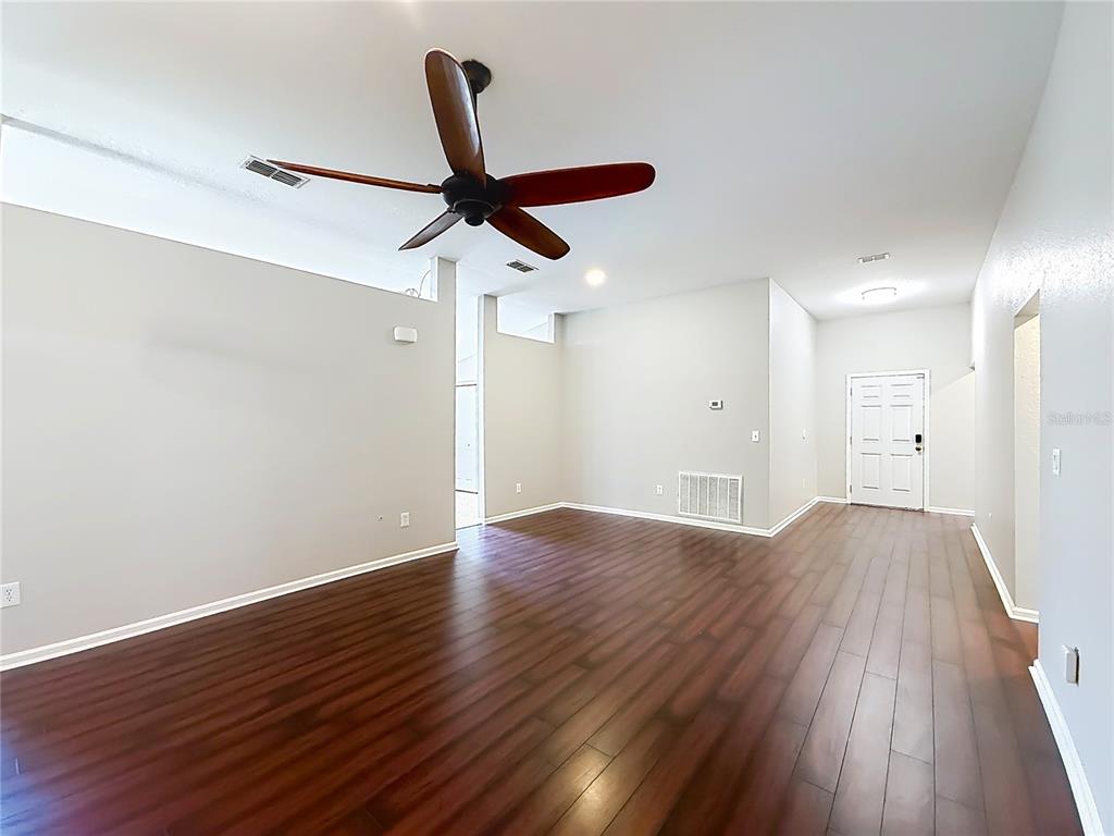 6358 Southwest 155th Place Ocala, FL 34473 - Photo 34 of 55 an empty room with wooden floor and windows