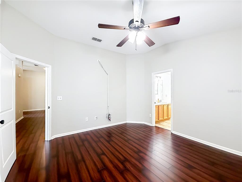 6358 Southwest 155th Place Ocala, FL 34473 - Photo 36 of 55 an empty room with wooden floor and windows