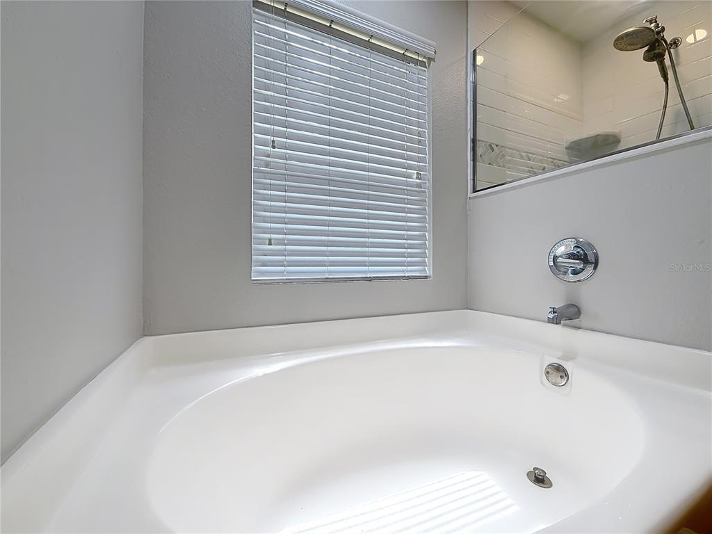 6358 Southwest 155th Place Ocala, FL 34473 - Photo 38 of 55 a white bath tub sitting in a bathroom