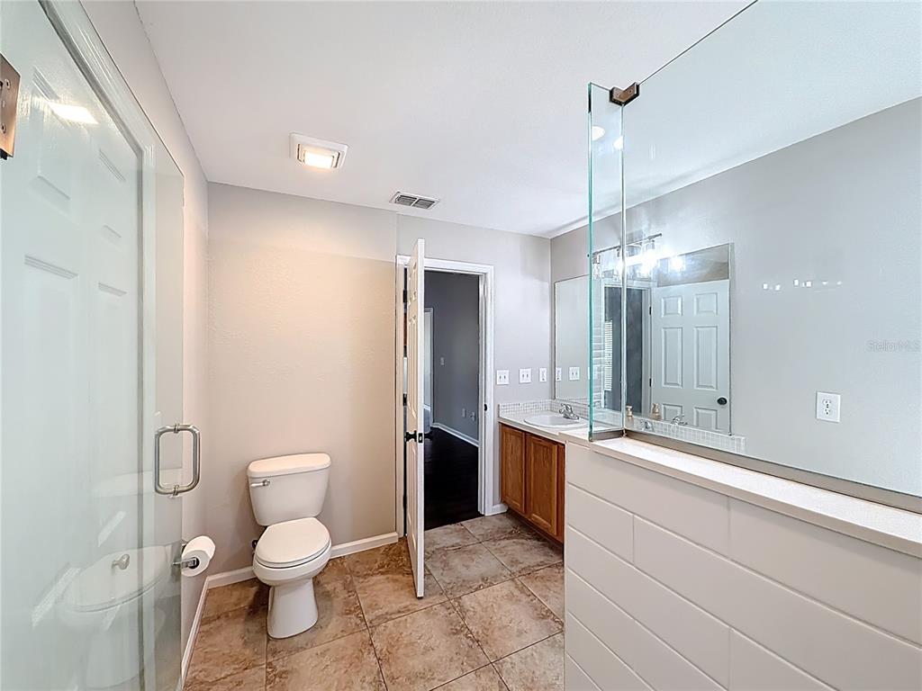 6358 Southwest 155th Place Ocala, FL 34473 - Photo 40 of 55 a spacious bathroom with a granite countertop sink a toilet and a shower