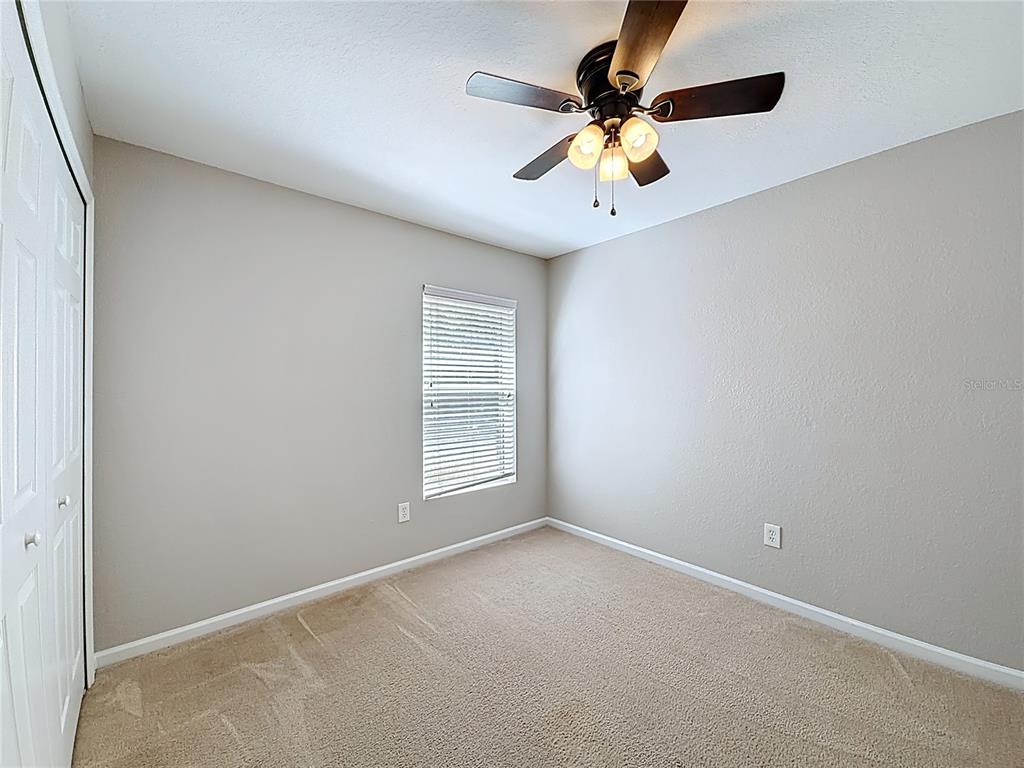 6358 Southwest 155th Place Ocala, FL 34473 - Photo 44 of 55 an empty room with a window and a fan