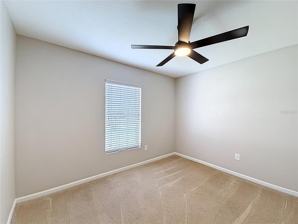 6358 Southwest 155th Place Ocala, FL 34473 - Photo 48 of 55 an empty room with windows and fan