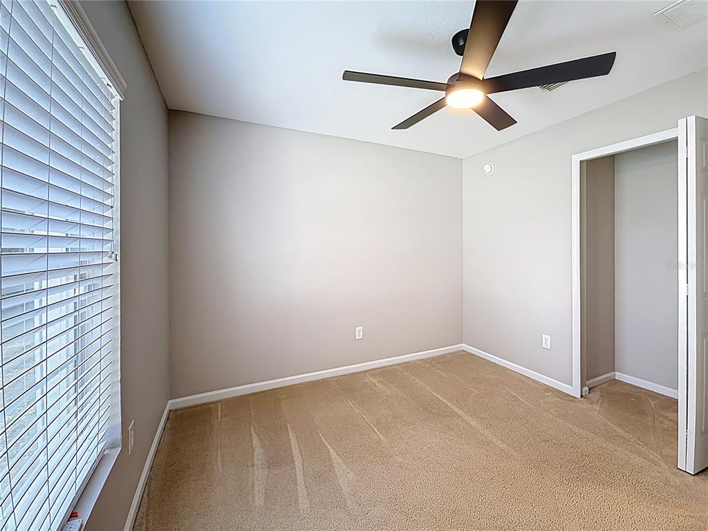 6358 Southwest 155th Place Ocala, FL 34473 - Photo 49 of 55 an empty room with a ceiling fan and a window