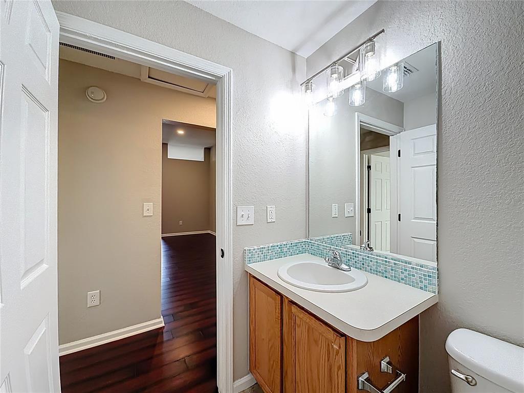 6358 Southwest 155th Place Ocala, FL 34473 - Photo 52 of 55 a bathroom with a sink a toilet and a mirror