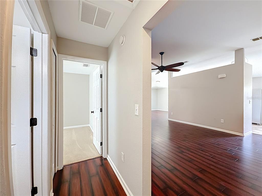 6358 Southwest 155th Place Ocala, FL 34473 - Photo 53 of 55 a view of a hallway with wooden floor and staircase