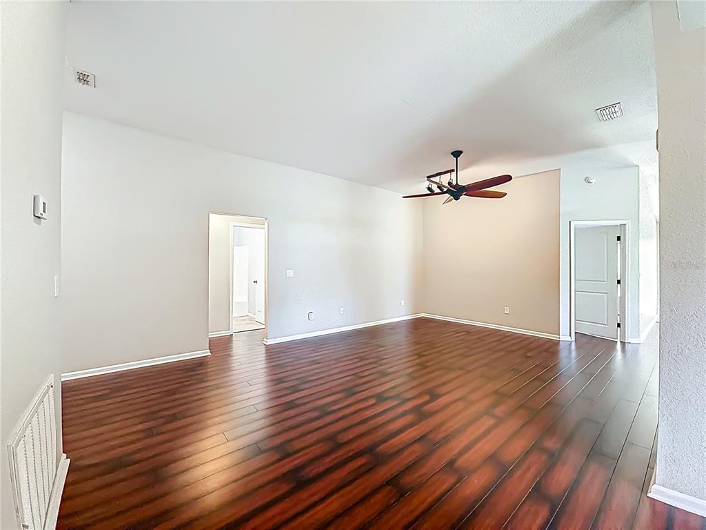 6358 Southwest 155th Place Ocala, FL 34473 - Photo 8 of 55 wooden floor in an empty room with a window