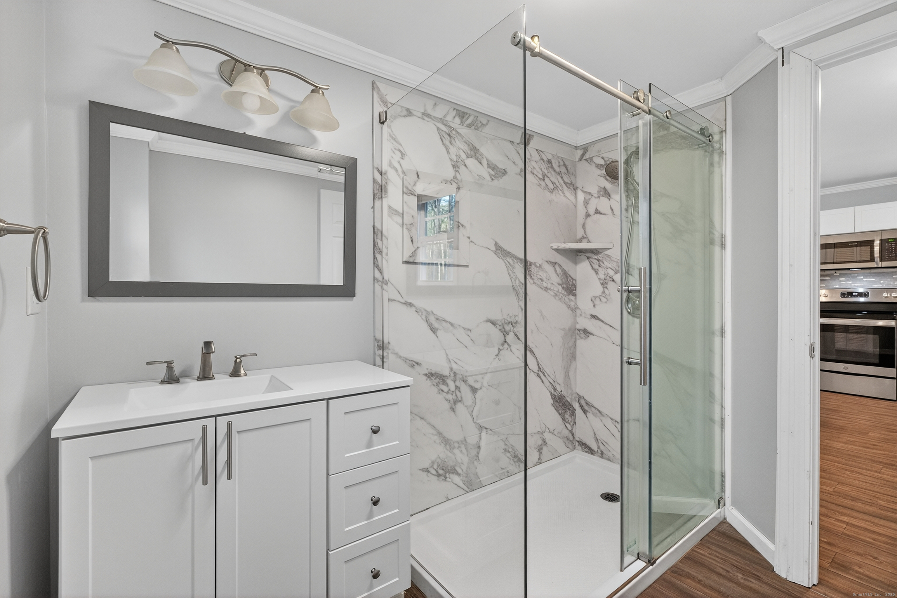 586 Back Road Windham, CT 06256 - Photo 18 of 32 a bathroom with a shower sink and mirror