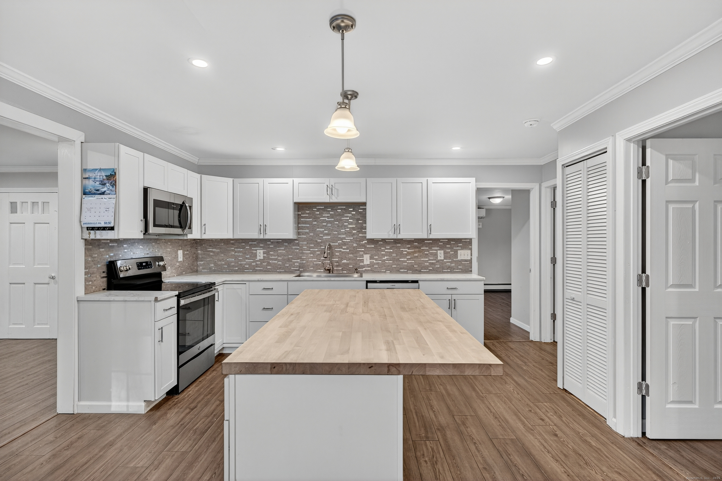 586 Back Road Windham, CT 06256 - Photo 4 of 32 a kitchen with a center island wooden floor and stainless steel appliances