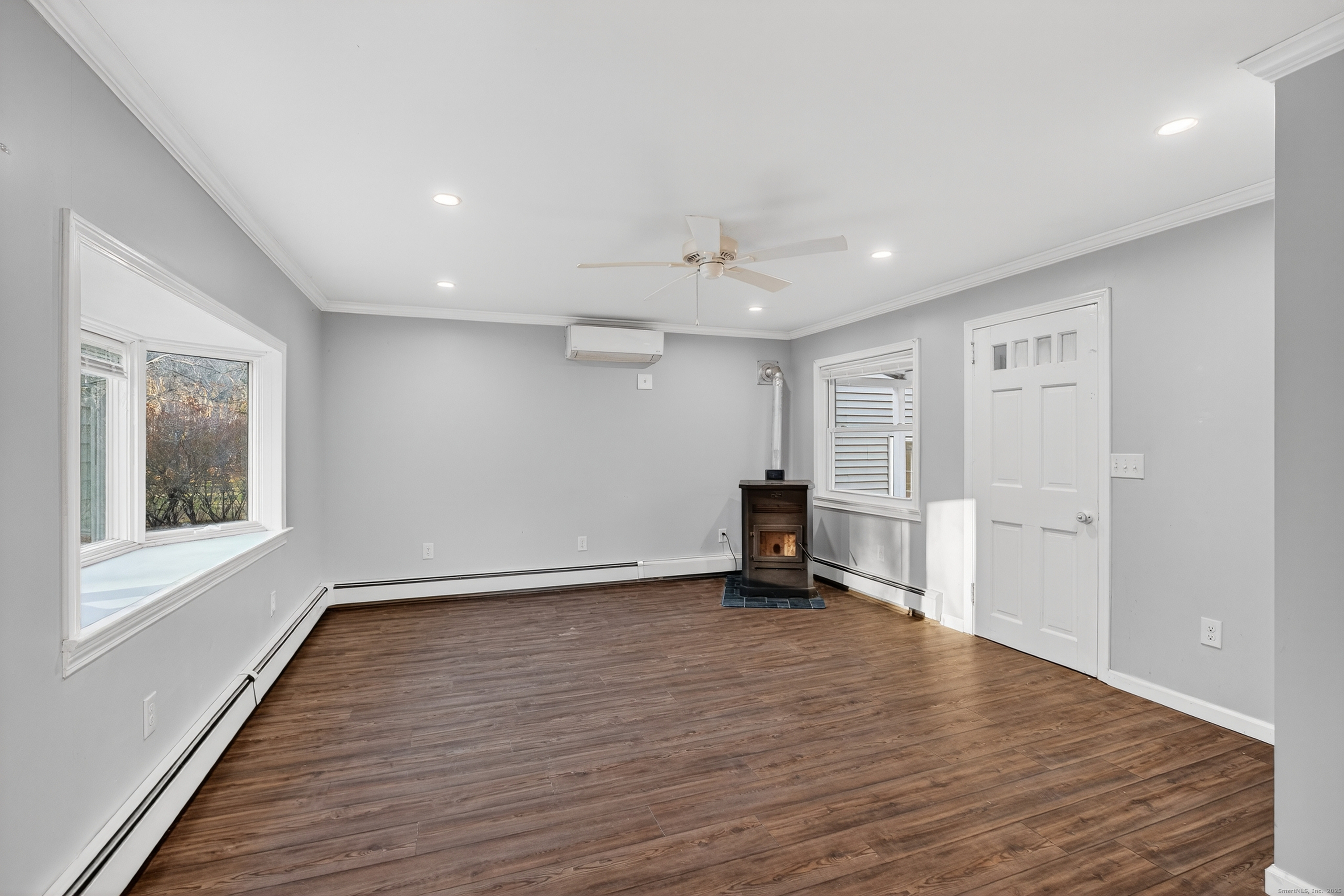 586 Back Road Windham, CT 06256 - Photo 10 of 32 a view of an empty room with a window and wooden floor