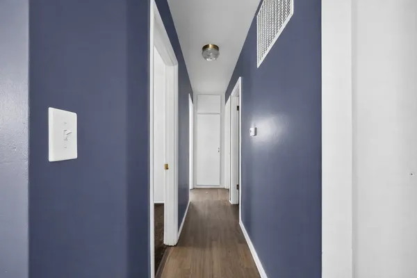 a view of hallway with wooden floor