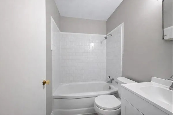 a bathroom with a toilet a sink and bathtub