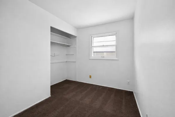 an empty room with a empty space and windows