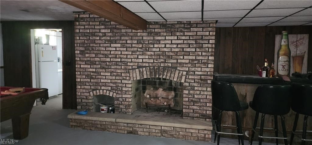 6699 Howard Road Williamsfield, OH 44093 - Photo 11 of 31 Living room with brick wall and a paneled ceiling