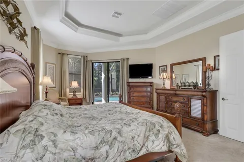 a bedroom with a bed and a television