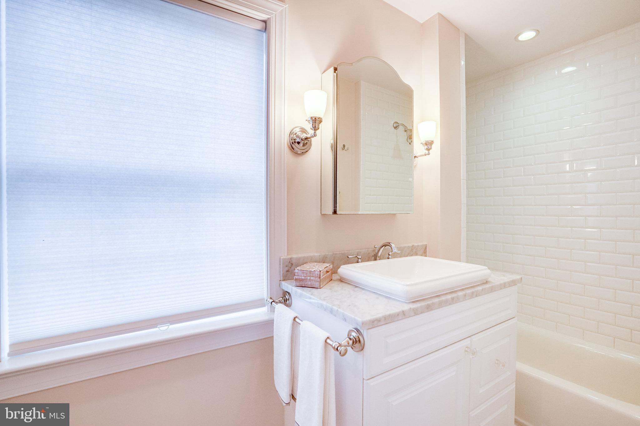 611 G Street Southeast Washington, DC 20003 - Photo 21 of 30 Marble topped vanity with tubbed shower