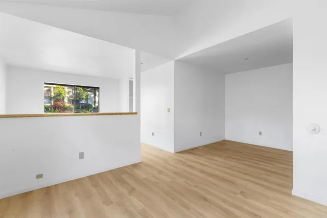 a view of a room with wooden floor and window