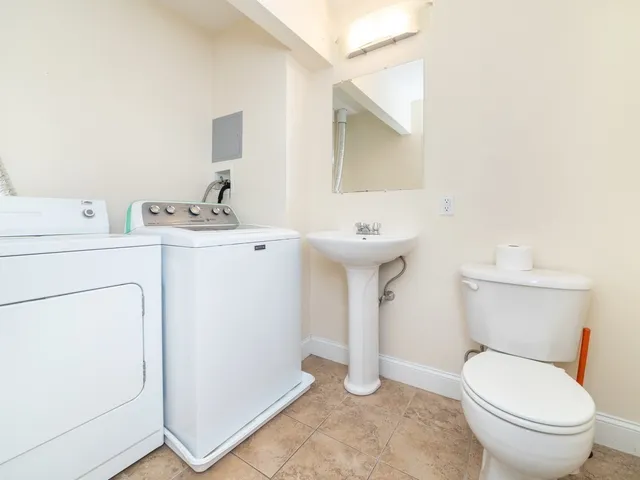 a white toilet sitting next to a bathroom sink