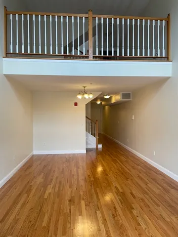 a view of a room with wooden floor