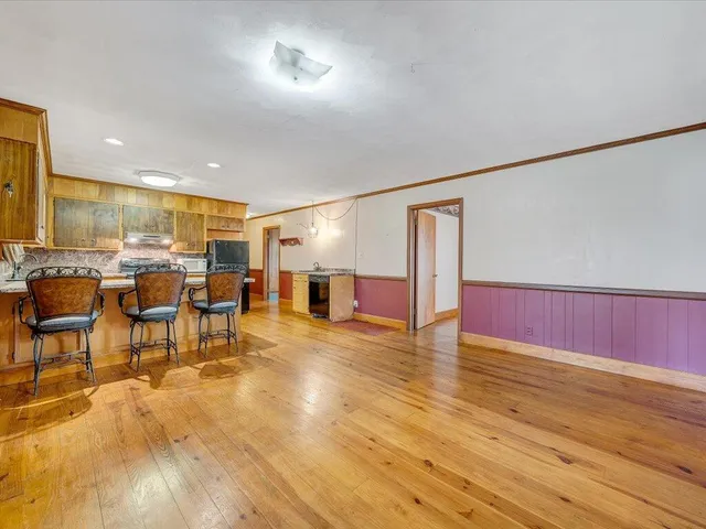 a view of a room with furniture and wooden floor