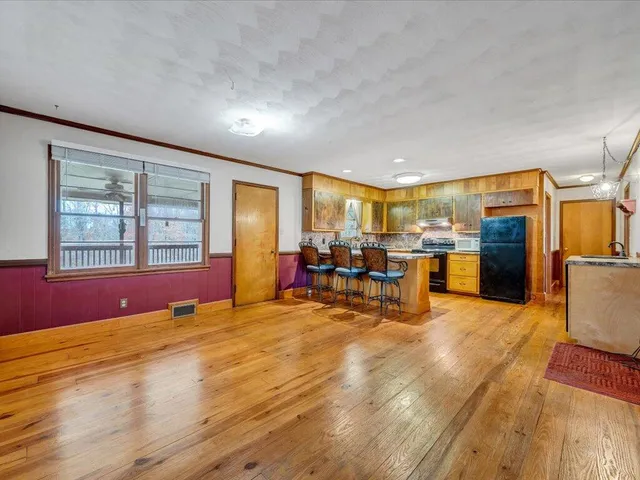 a view of livingroom with furniture wooden floor and windows