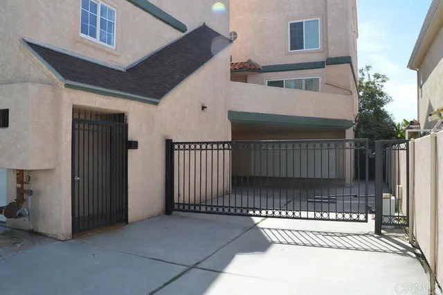 a view of a house with a small yard and wooden floor and fence