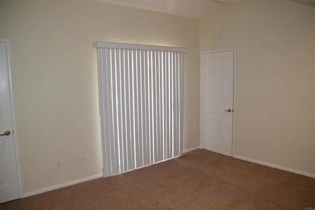 a view of a livingroom and an empty room