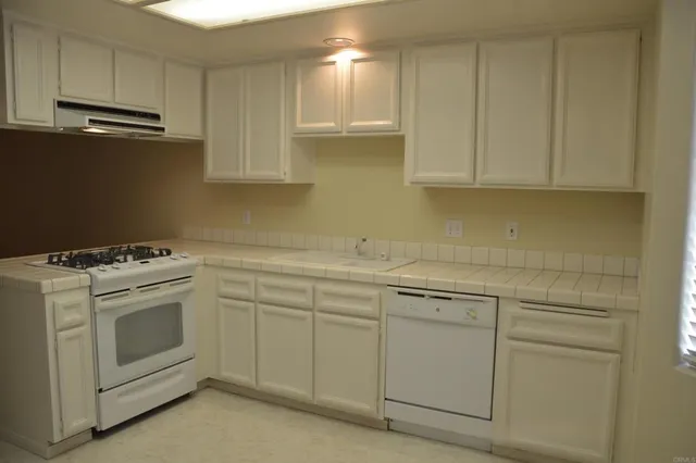 a view of a storage and utility room with washer and dryer