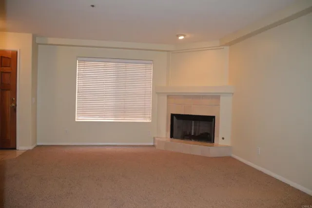 a view of empty room with a fireplace
