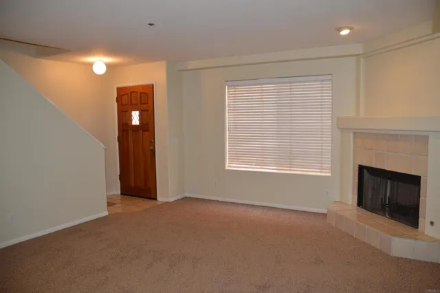 a view of livingroom with a fireplace window and a kitchen space