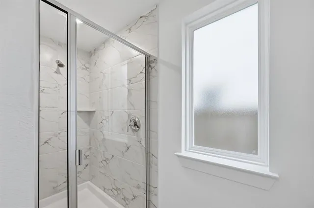 a bathroom with a glass shower door