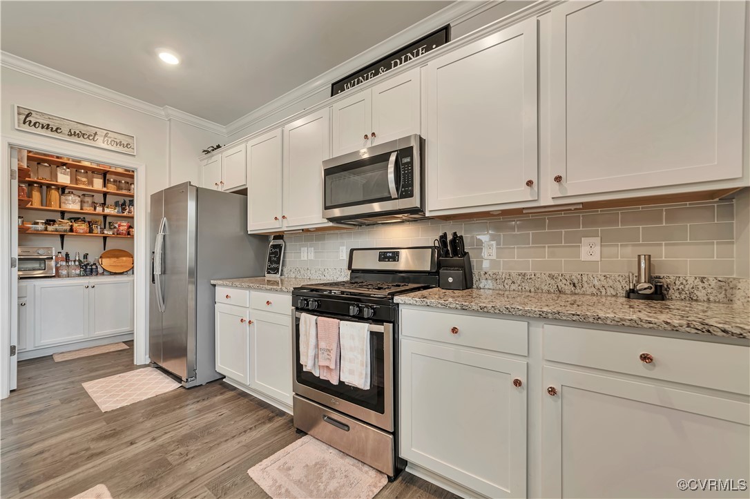 7232 Cress Terrace New Kent, VA 23124 - Photo 12 of 42 a kitchen with stainless steel appliances granite countertop a stove a sink and a refrigerator