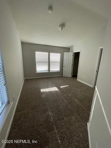 a bathroom with a granite countertop sink a toilet a mirror and bathtub